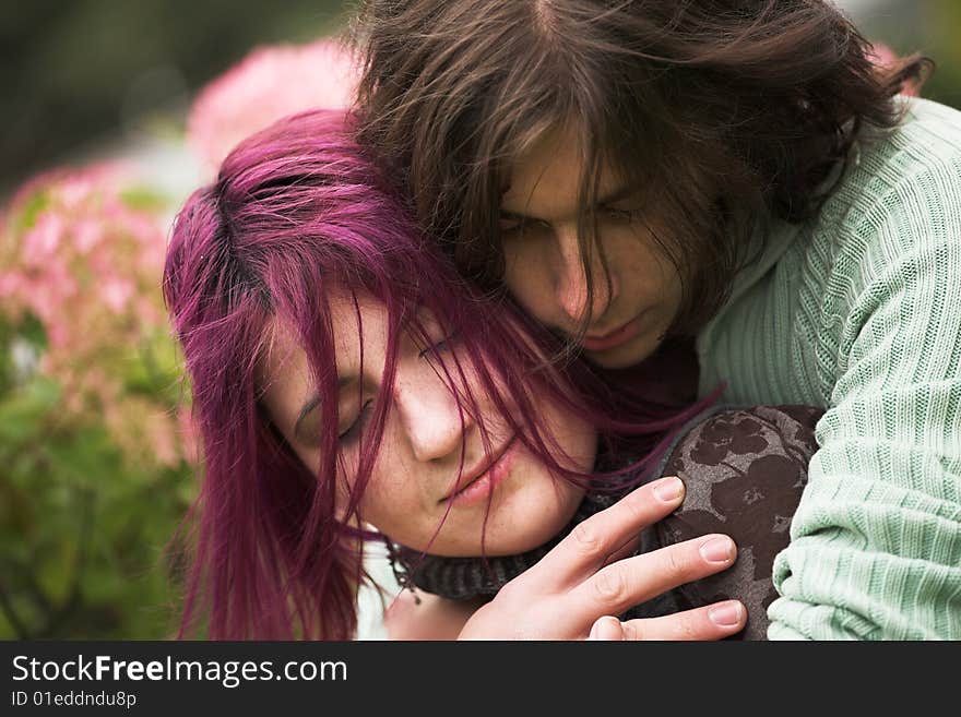 Attractive man and woman couple in love in the park. Attractive man and woman couple in love in the park