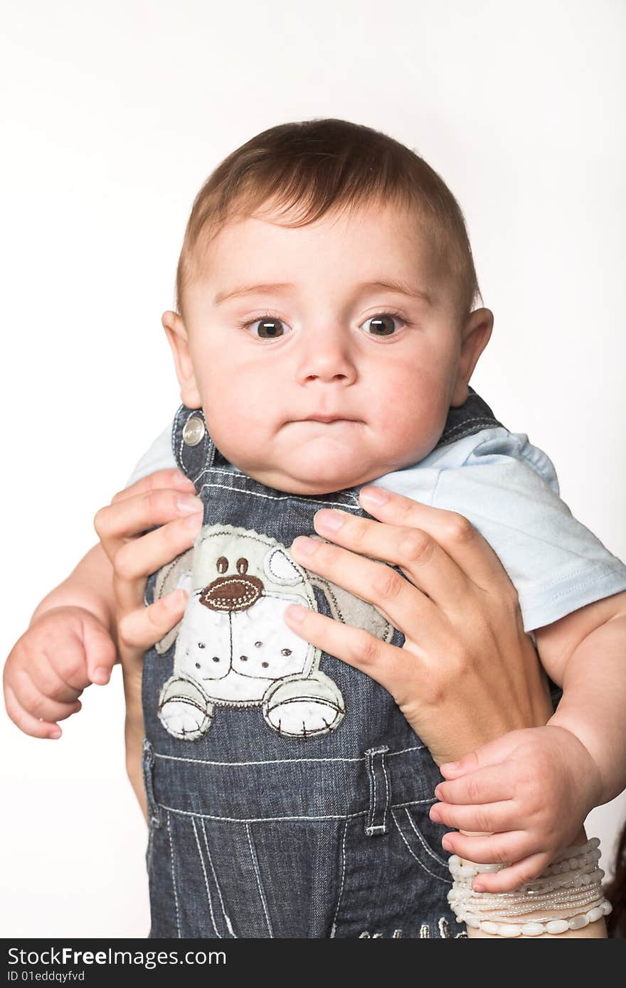 Close-up studio portait of a cute child holding by his mother