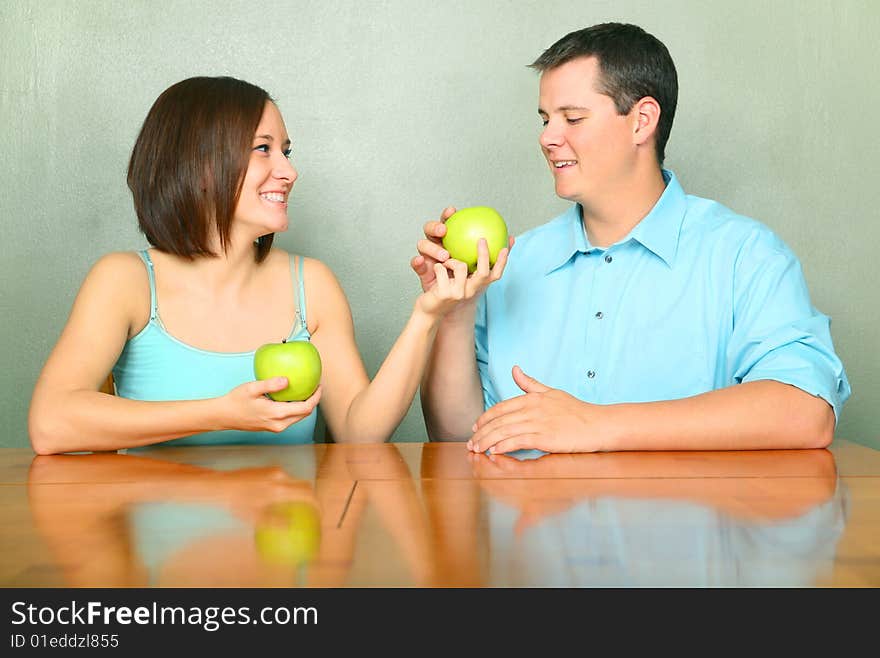 Young Adults Caucasian Couple Sharing Green Apple