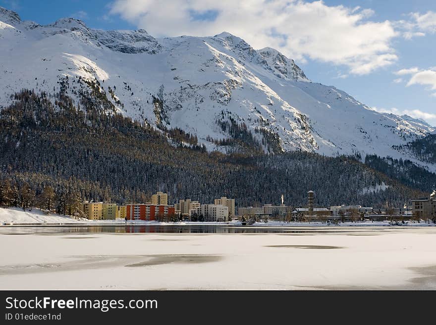 Modern hotels and apartments breaking the enchant of a snowy mountain environment in St. Moritz lake. Switzerland. Modern hotels and apartments breaking the enchant of a snowy mountain environment in St. Moritz lake. Switzerland.