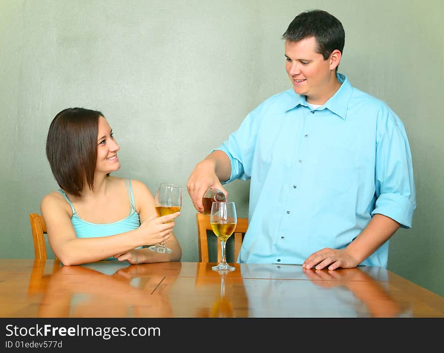 Happy couple enjoying wine. caucasian male pouring wine for his girlfriend or wife. Happy couple enjoying wine. caucasian male pouring wine for his girlfriend or wife