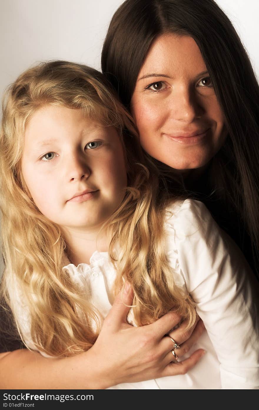 Young mother and daughter, studio shot,