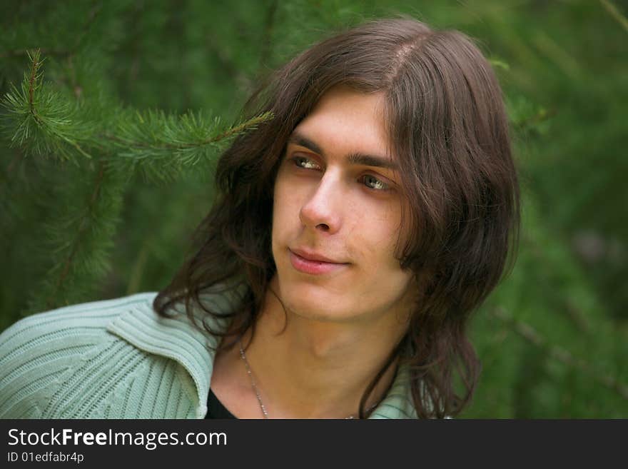 Portrait of a handsome young man during his walk in a park