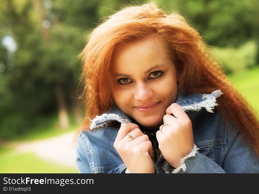 Young red girl in park