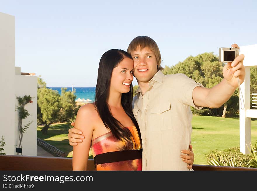 Young couple taking a photo of themselves on the balcony