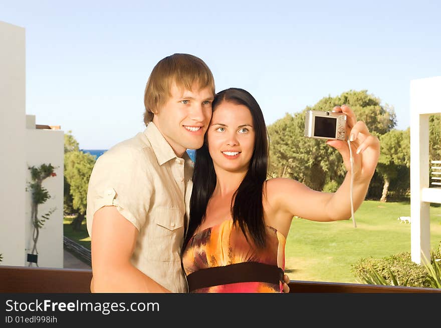 Young couple taking a photo of themselves on the balcony