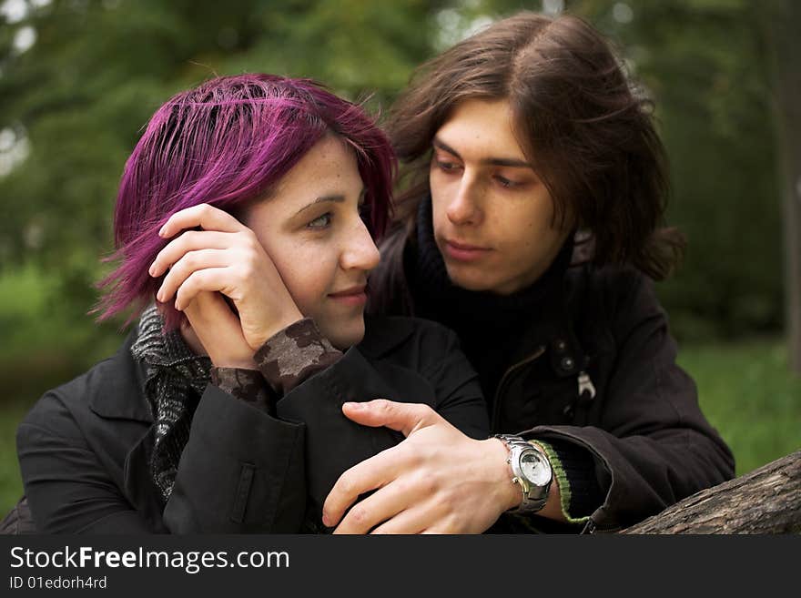 Portrait of a loving couple in a park. Portrait of a loving couple in a park