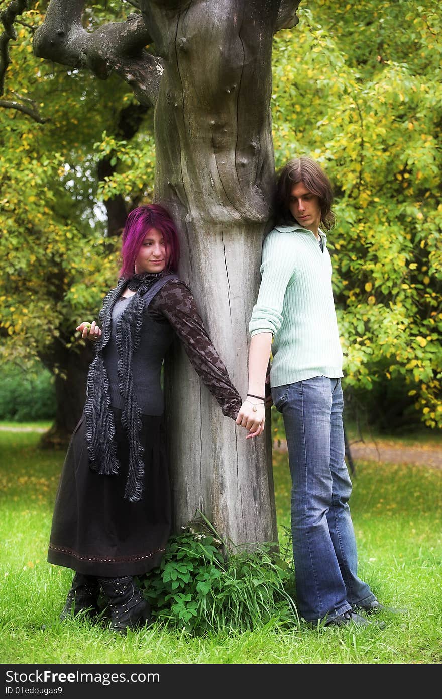 Attractive man and woman couple in love in the park. Attractive man and woman couple in love in the park