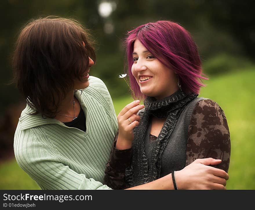 Attractive man and woman couple in love in the park. Attractive man and woman couple in love in the park