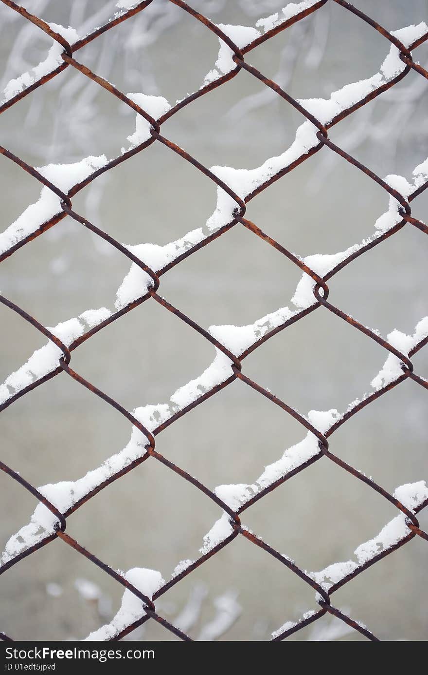 Rusty Wire Fence Under Snow