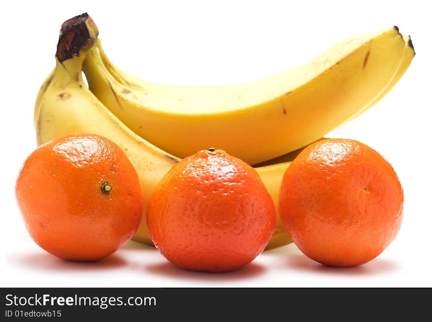 Bundles of bananas and three tangerines isolated on a white background. Bundles of bananas and three tangerines isolated on a white background.