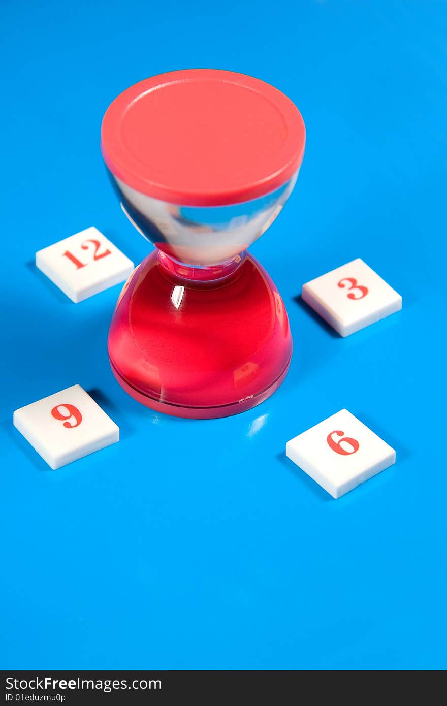 Red liquid hourglass and digits symbolizing hours (on a bright blue background)