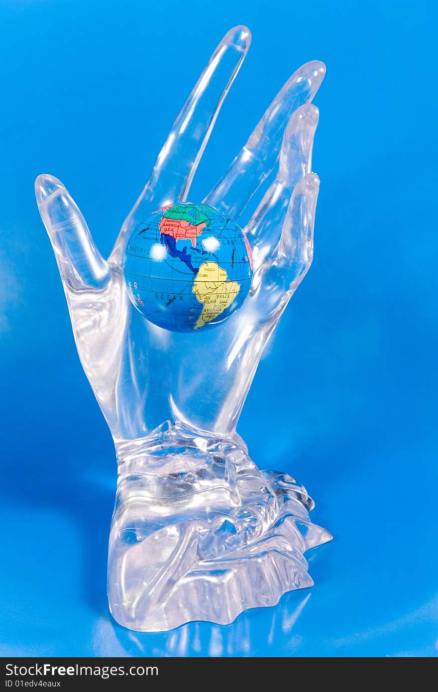 Small globe in a glass hand