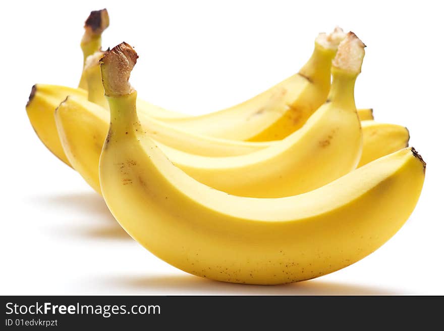 Several bananas isolated on a white background. Background blurred. Several bananas isolated on a white background. Background blurred.