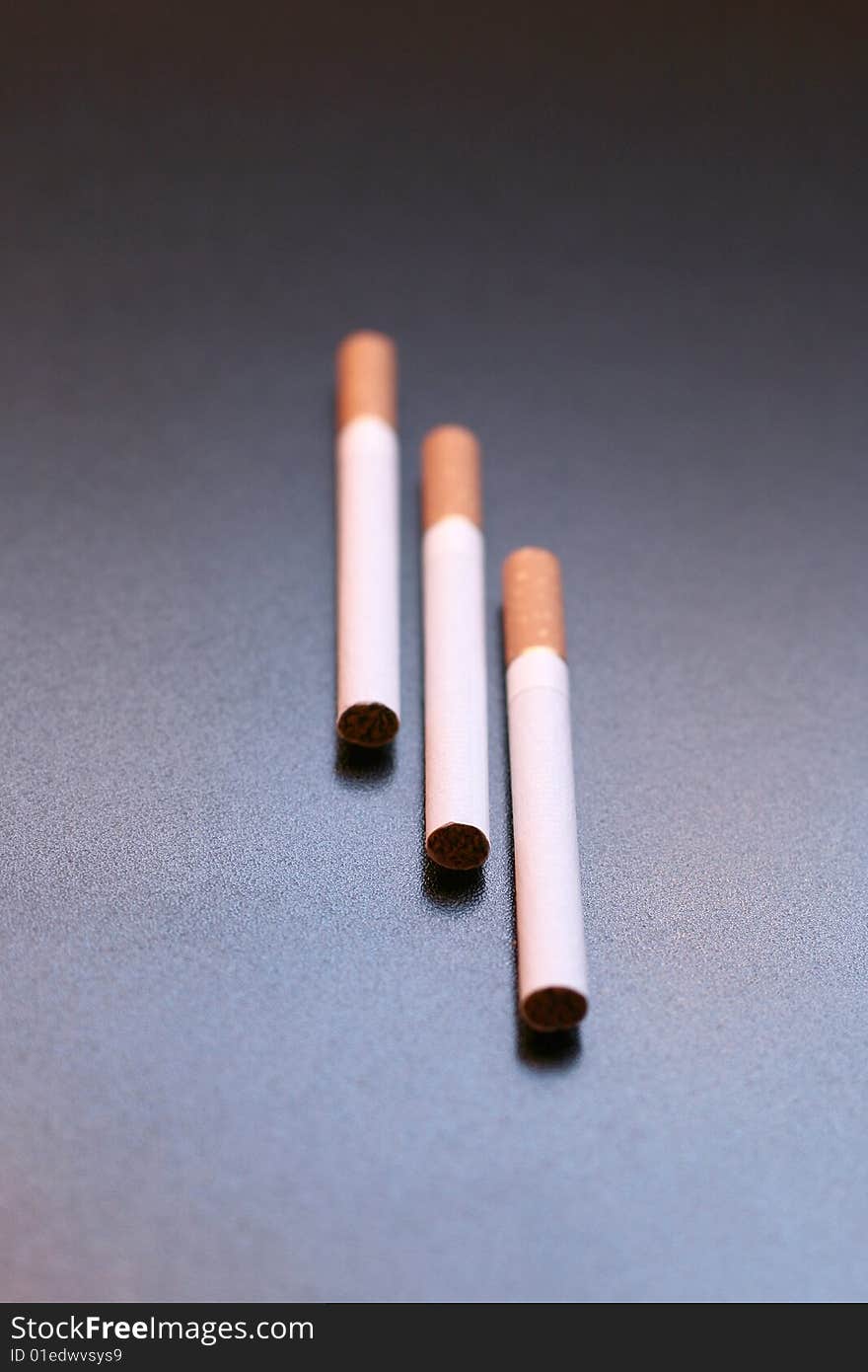 3 cigarettes on a black background