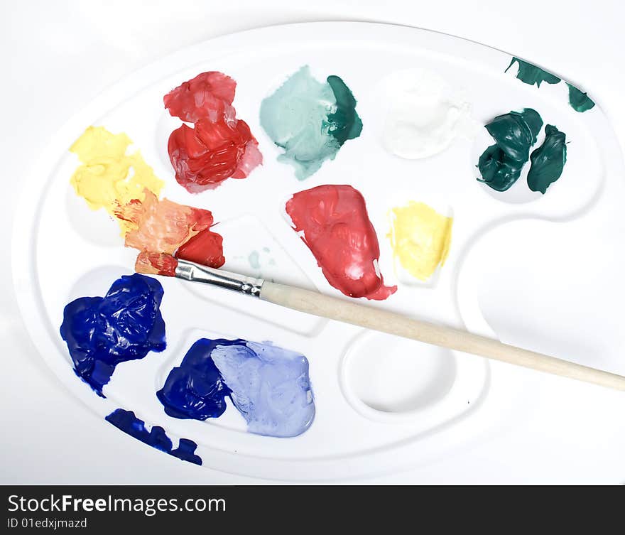 Palette With Paints And Paintbrush