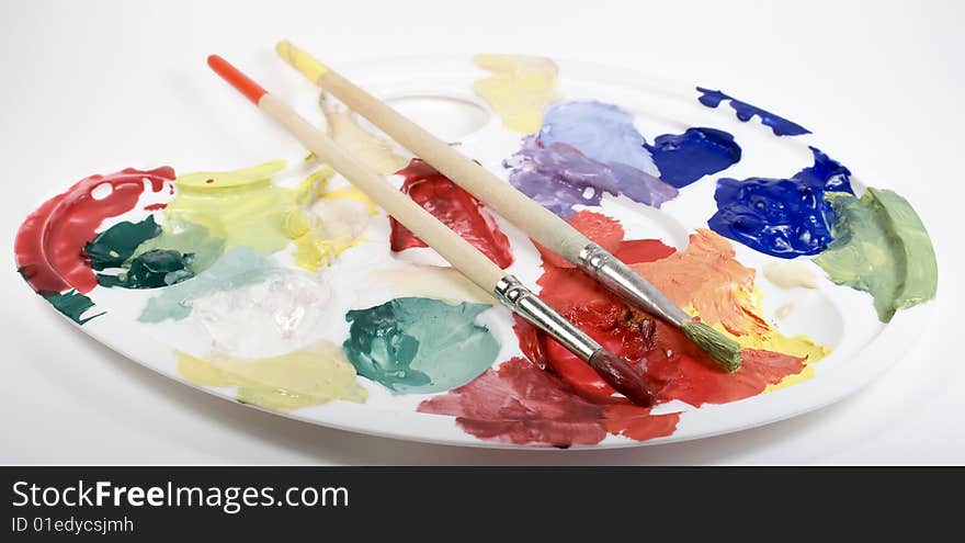 Palette With Paints And Two Paintbrushes