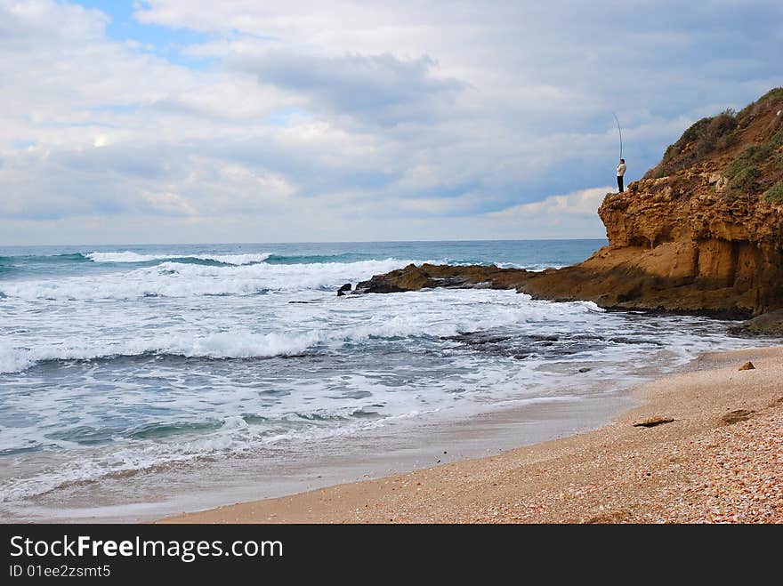 Fisherman on a rock