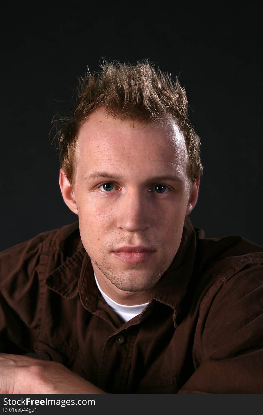 Attractive man looking directly into camera; hair is spiked