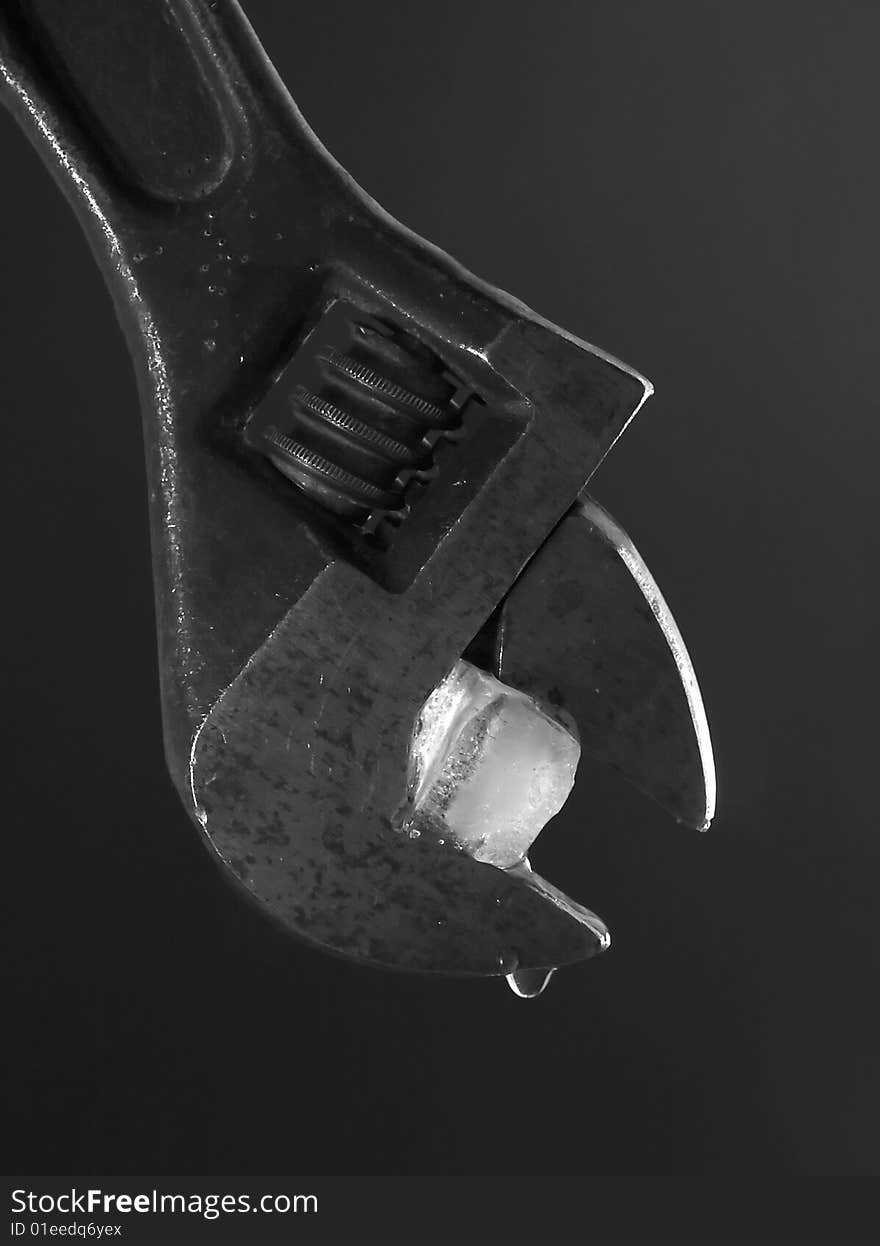 Flat wrench with ice on dark background