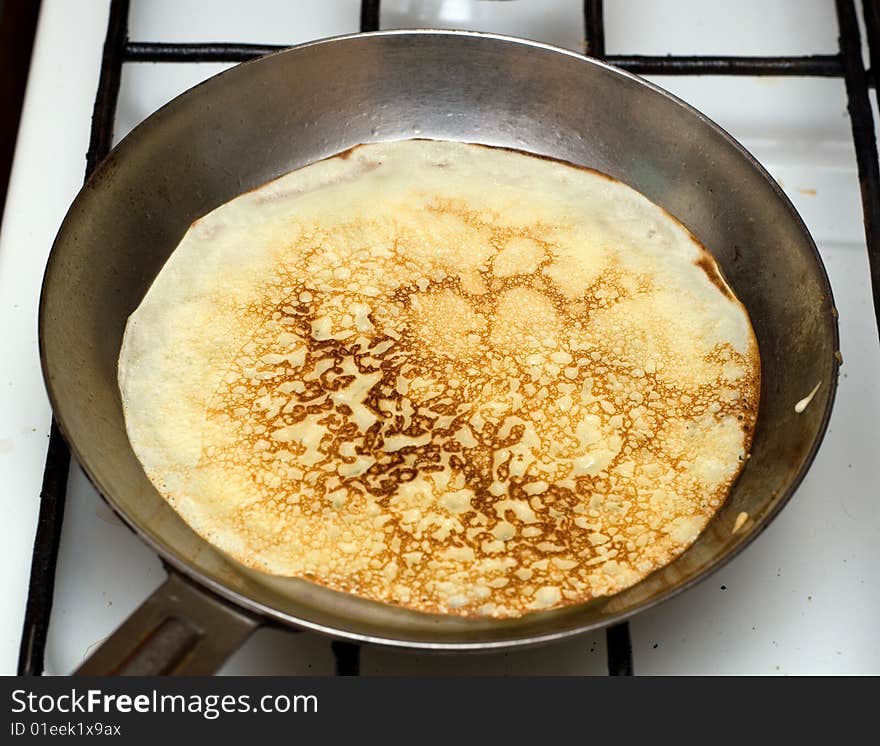 Cooking pancakes in to a frying pan. Traditional food