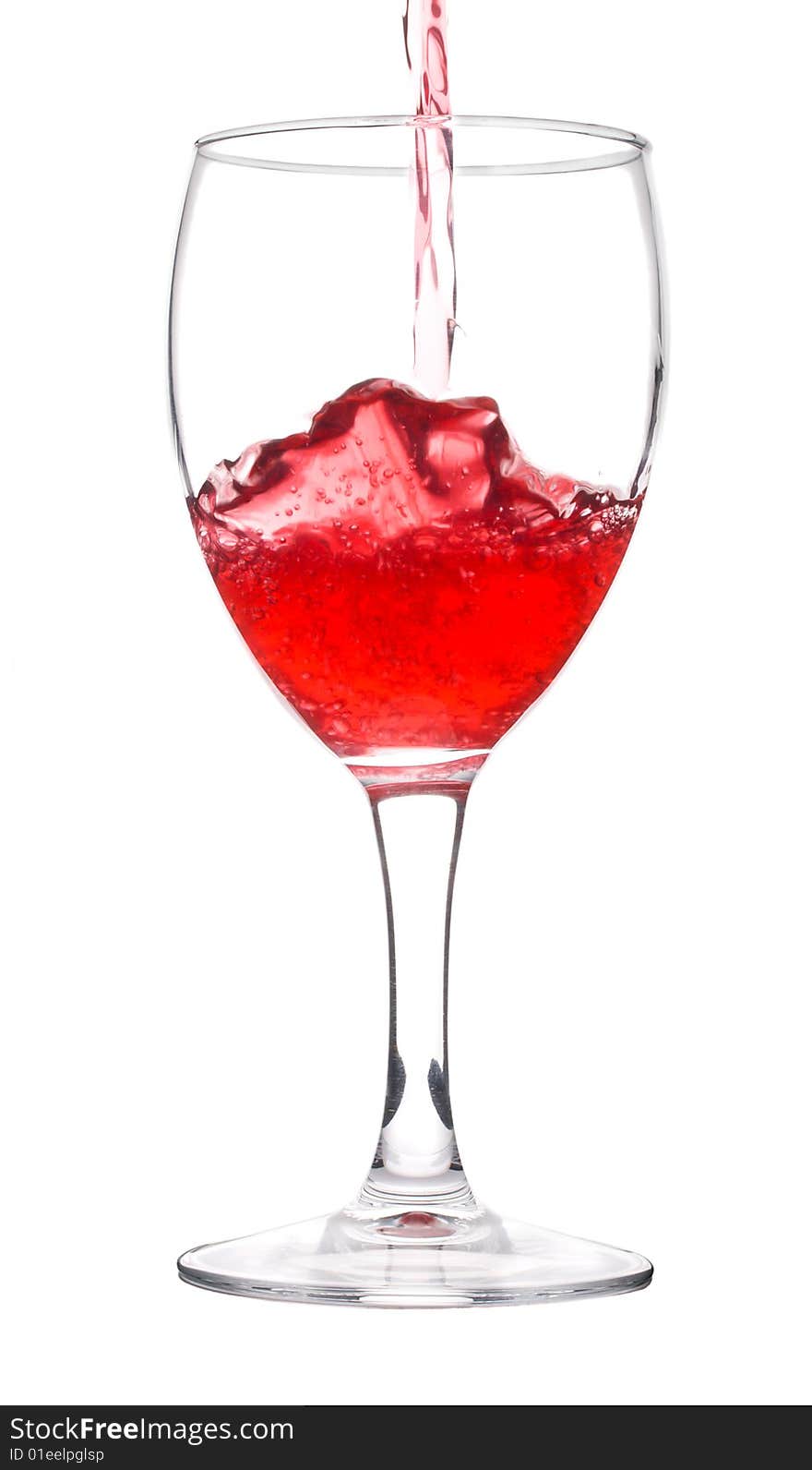 Red wine pouring in glass, isolated on white