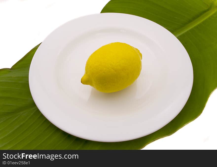 Lemon  on a white plate the isolated on a white background