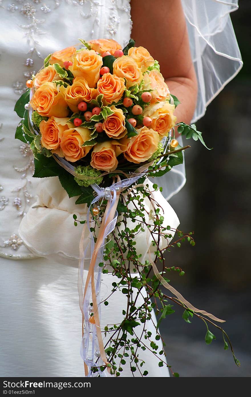 Bride holds a beautiful bouquet of roses