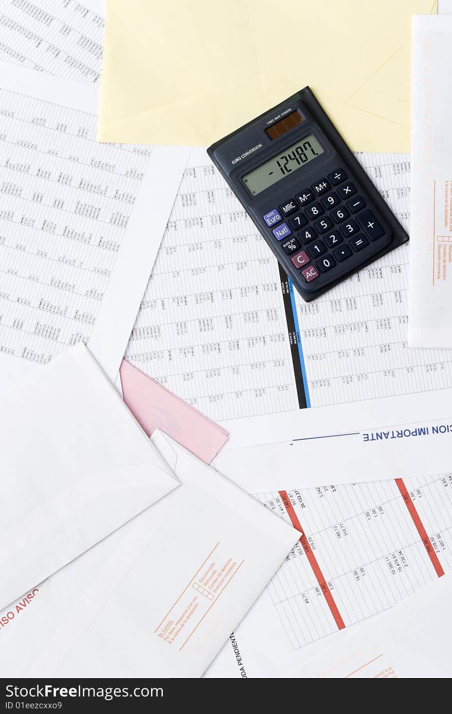 A calculator on top of financial reports. A calculator on top of financial reports.