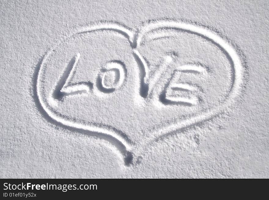 Heart drawn on the snow with title LOVE. Heart drawn on the snow with title LOVE