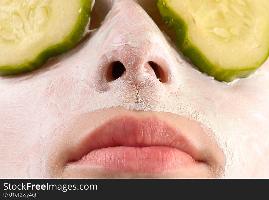 Woman with cucumbers and face mask. Woman with cucumbers and face mask