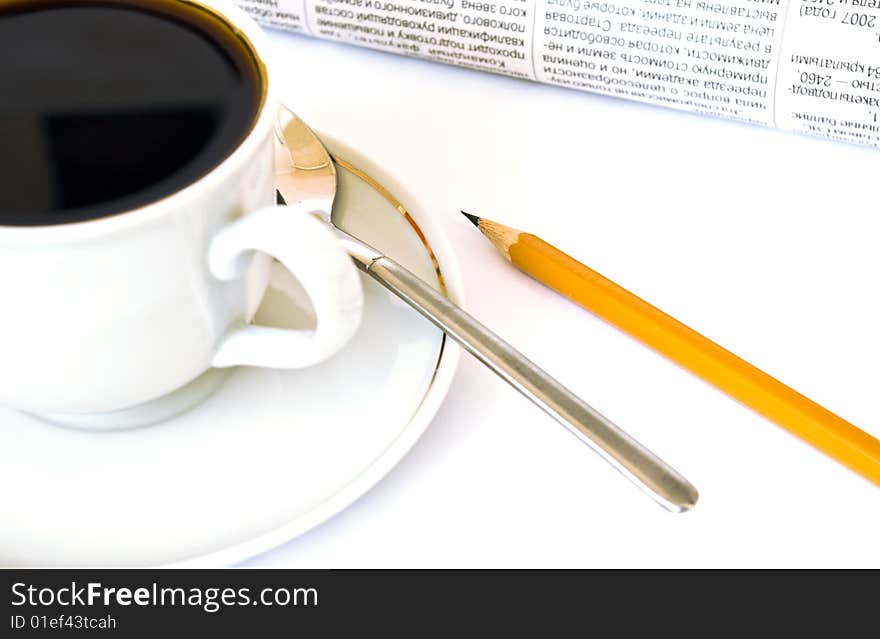 Cup of coffee and newspaper on white background