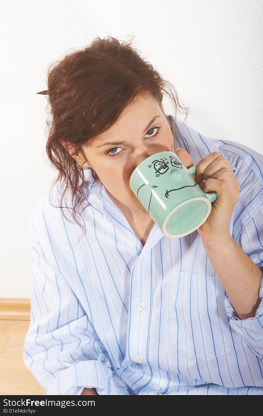 A young woman drinks a cofee in the morning. A young woman drinks a cofee in the morning.