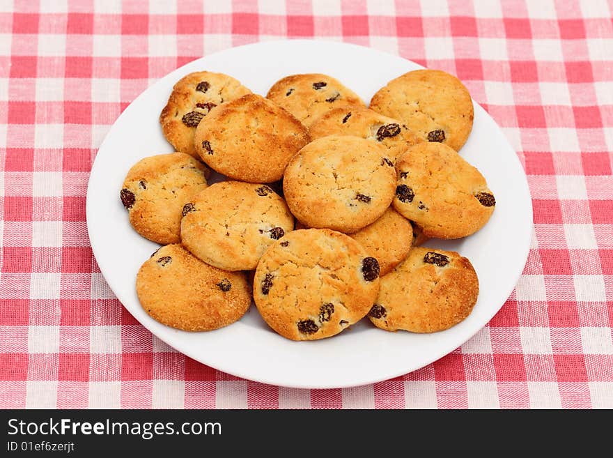 Plate of chocolate chip cookies on checked tablecloth. Plate of chocolate chip cookies on checked tablecloth