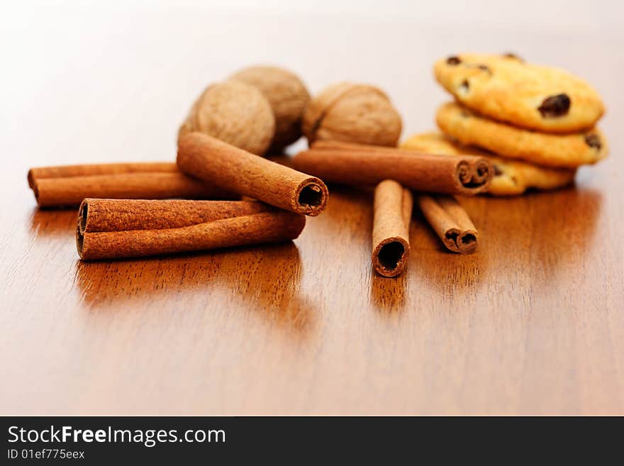 Cinnamon, circassian walnut and cookies on the table background. Cinnamon, circassian walnut and cookies on the table background.