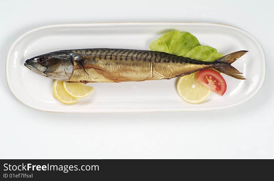 Smoked mackerel on a white platter