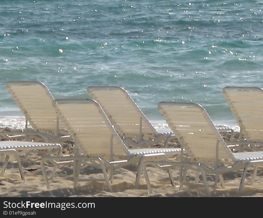 Chairs lined up at a resort along the beach at a resort in the Bahamas. Chairs lined up at a resort along the beach at a resort in the Bahamas.