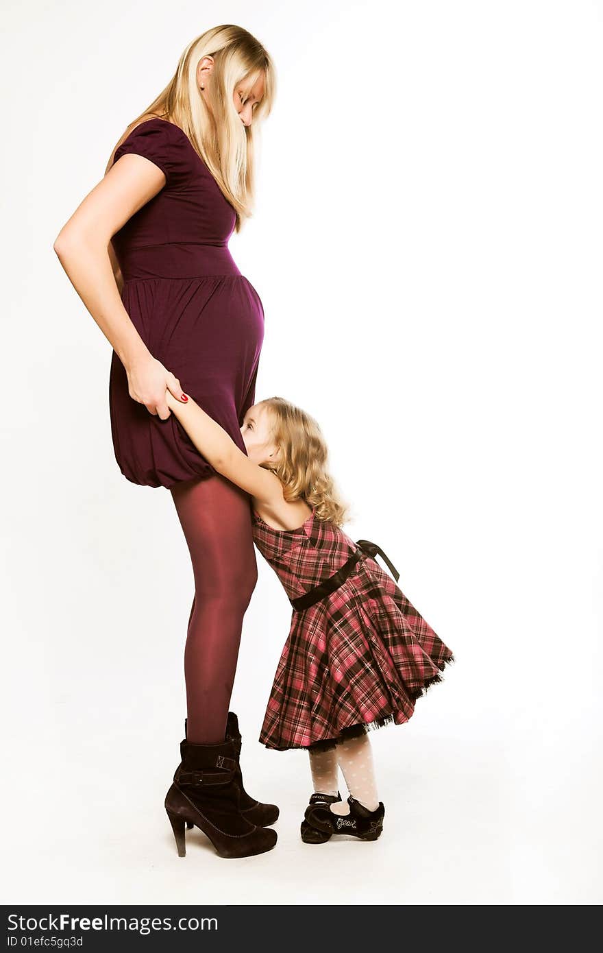 Portrait young beautiful pregnant woman with little daughter