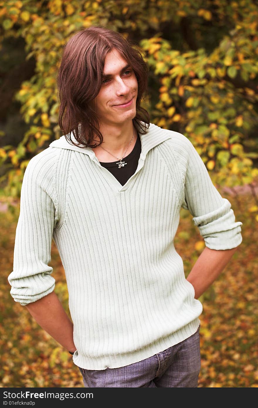 Portrait of a handsome young man during his walk in a park