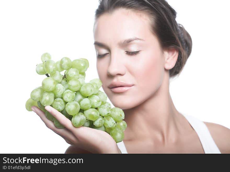 Studio portrait of a girl with a bunch of grapes isolated on white background. Studio portrait of a girl with a bunch of grapes isolated on white background