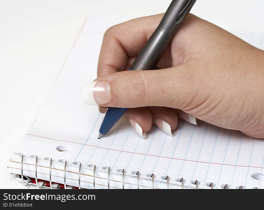 A macro picture of a female hand holding a pen. A macro picture of a female hand holding a pen