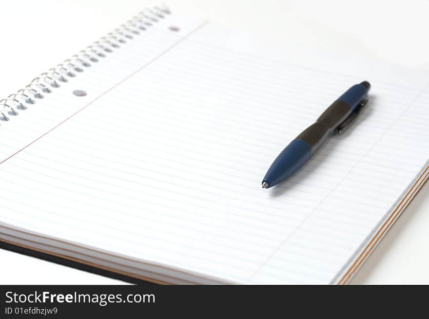 A macro picture of a pen and notebook. A macro picture of a pen and notebook