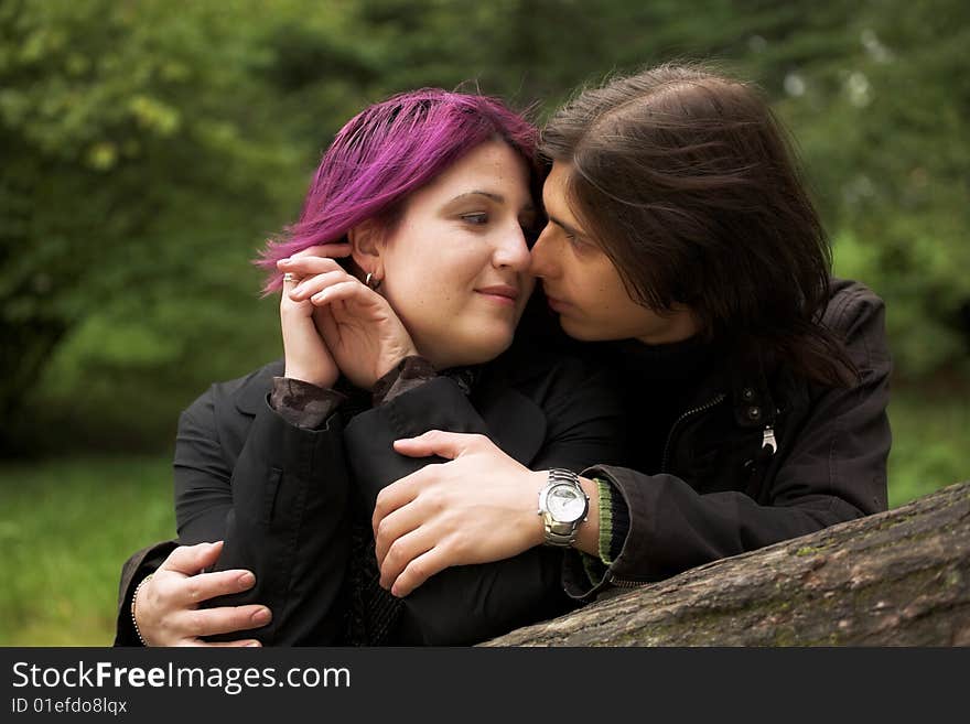 Portrait of a loving couple in a park. Portrait of a loving couple in a park