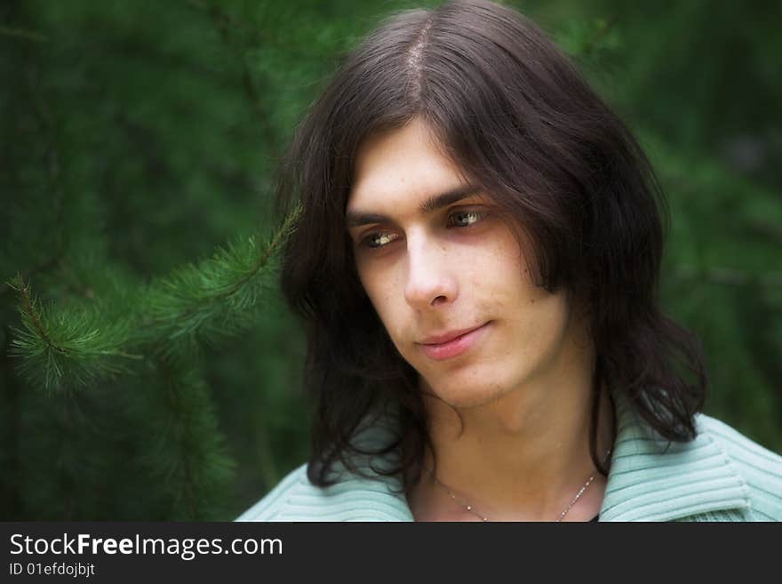 Portrait of a handsome young man during his walk in a park