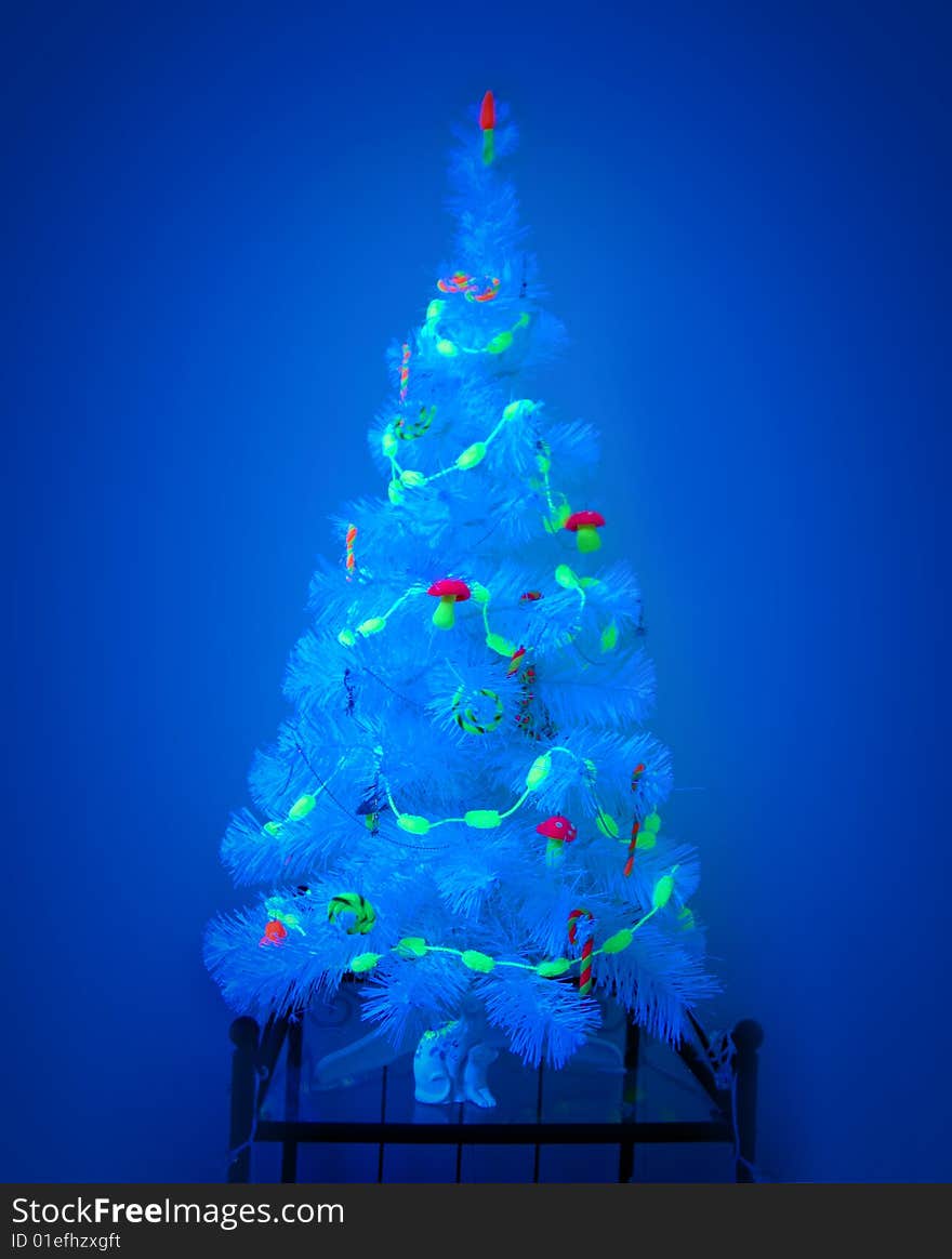 Unusual Christmas tree in a blacklight. Unusual Christmas tree in a blacklight