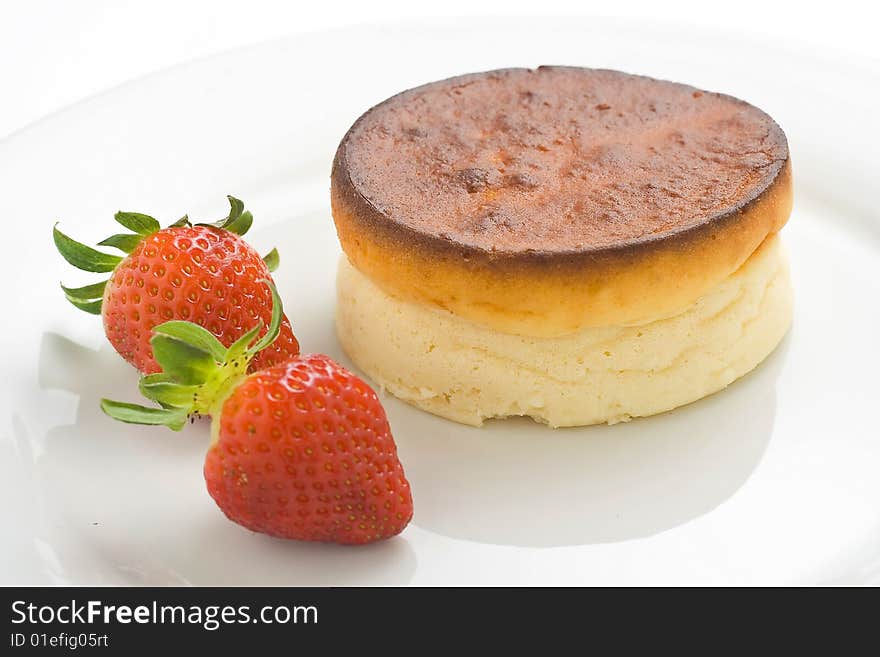 Cheesecake with fresh strawberries and blackberry jam isolated over white