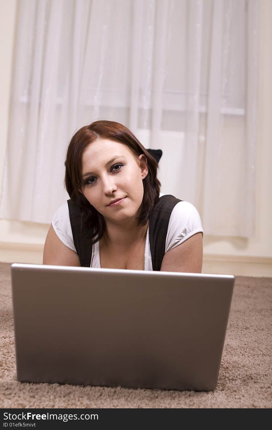 Woman with laptop on carpet