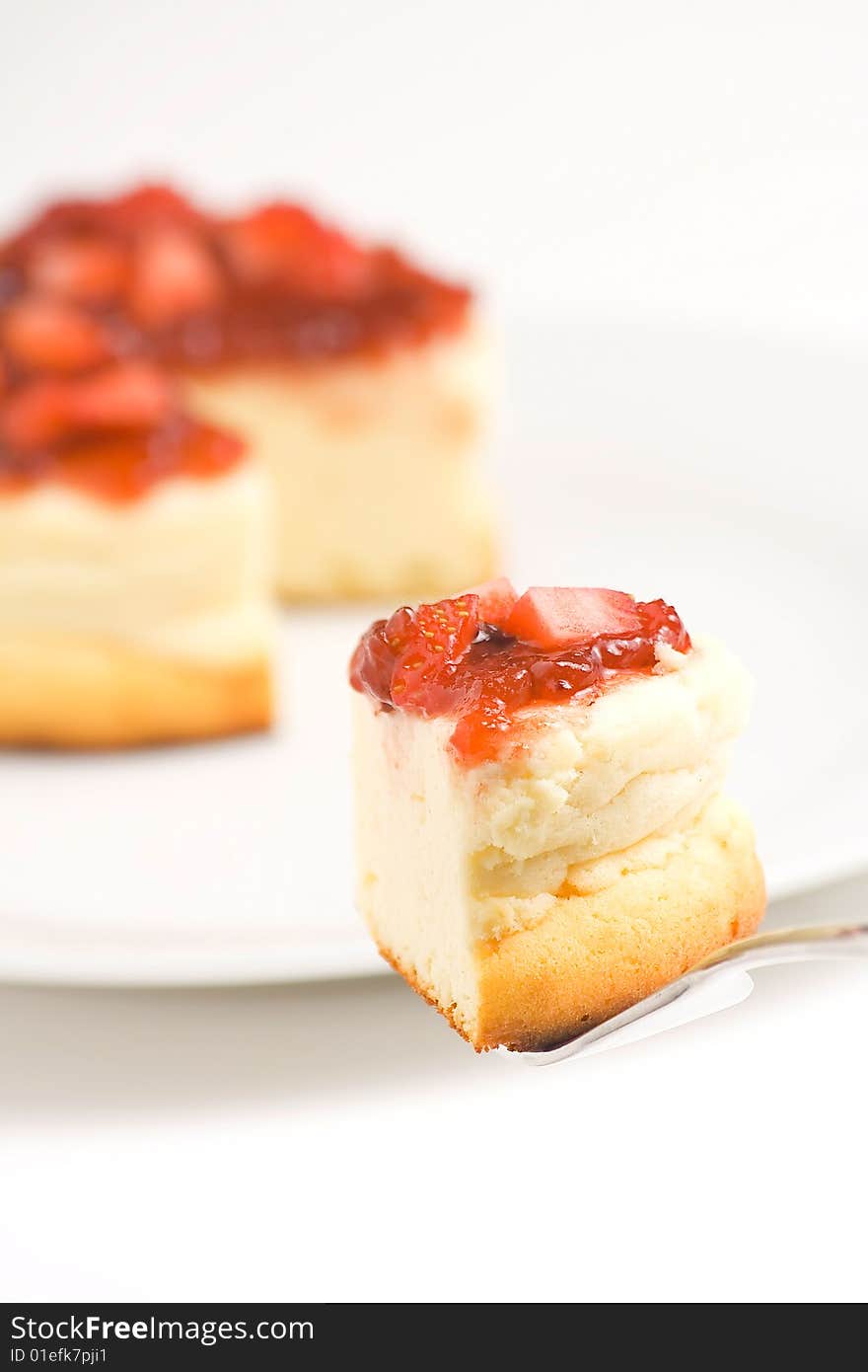 Cheesecake with fresh strawberries and blackberry jam isolated over white