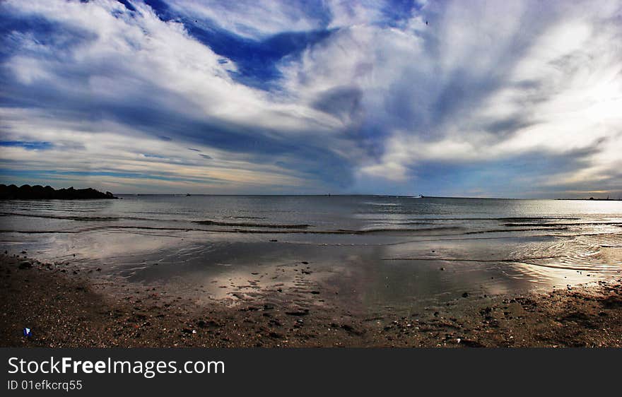 An illusion of depth is created as the clouds and water tend to converge at the horizon. All these together create a mysterious evening.