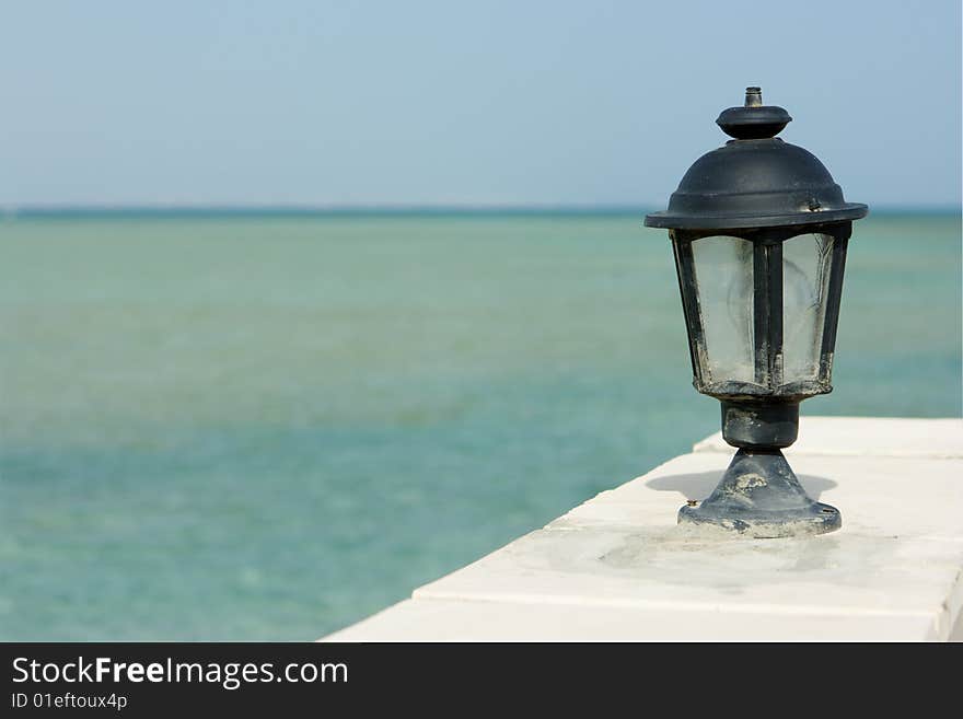 Lamp and sea on background